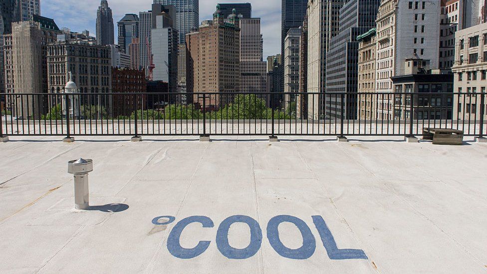 Cool, white roofing materials to cool the roof of a federal building on Broadway in New York City. The word Cool has been spelled out on the rooftop of this building.