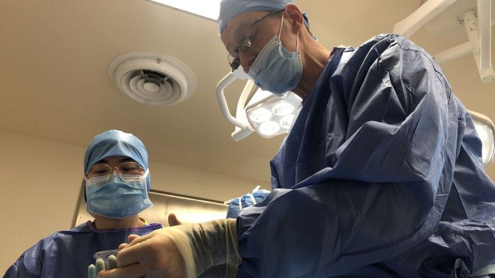 Surgeon Serryth Colbert performs a dental extraction in an operating theatre