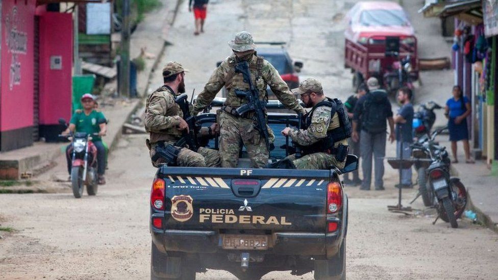 Experts from the Federal Police from the Task Force are taken on a pick-up truck upon arriving at the port of Atalaia do Norte, a municipality in the state of Amazonas, Brazil, on 14 June 2022