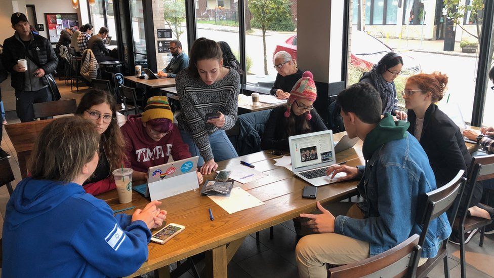 The children gather around a table in Starbucks