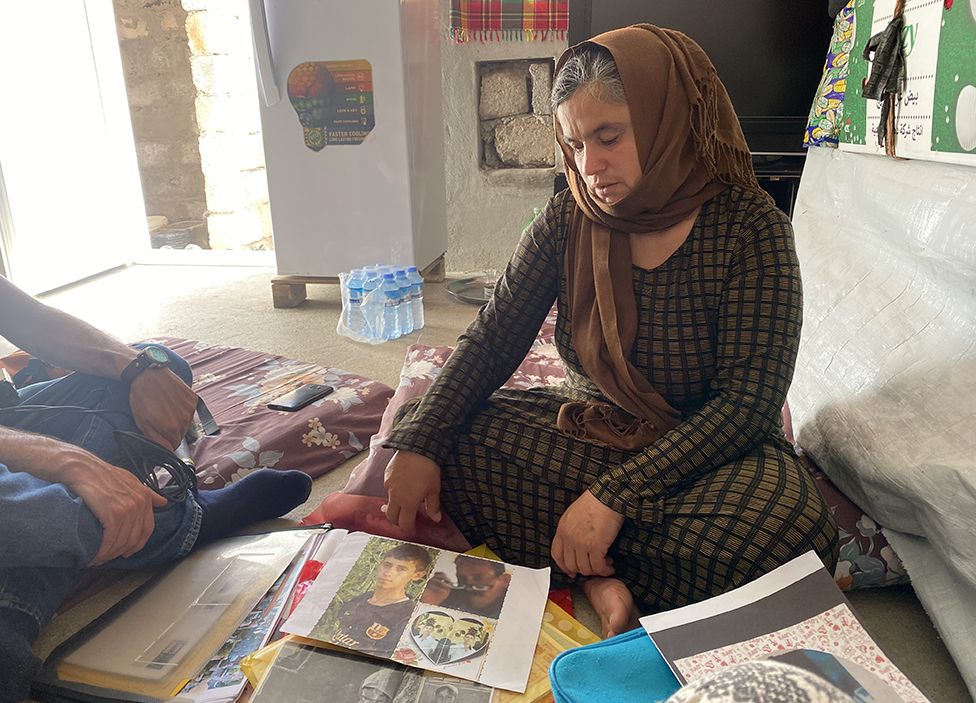 Bahar looks at pictures of her missing husband and son, now presumed murdered