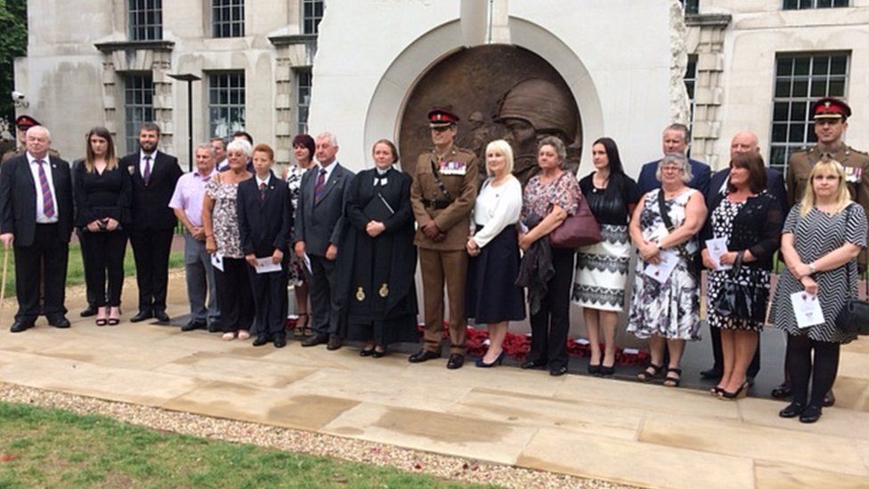 Families gather in front of the memorial