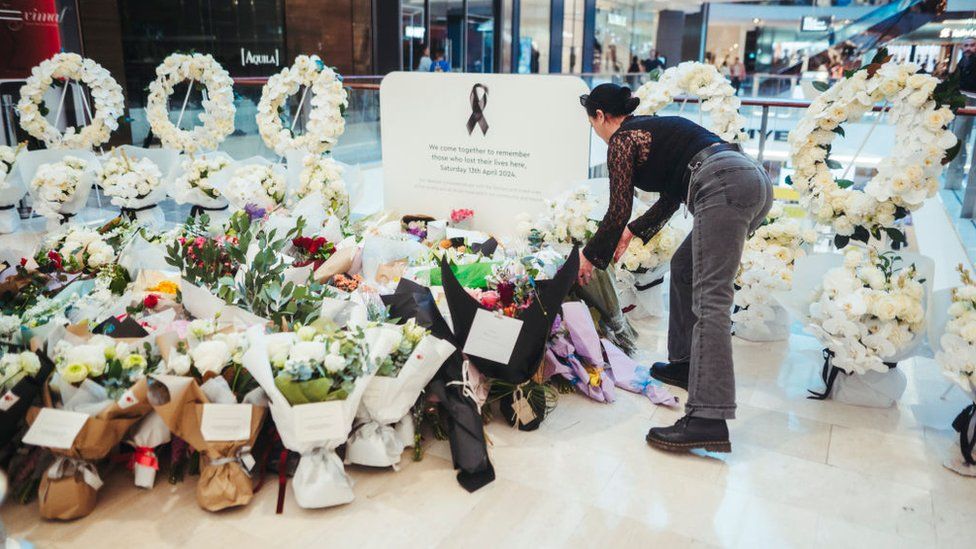 Members of the public pay their respects at the Westfield Bondi Junction shopping centre during a day of reflection