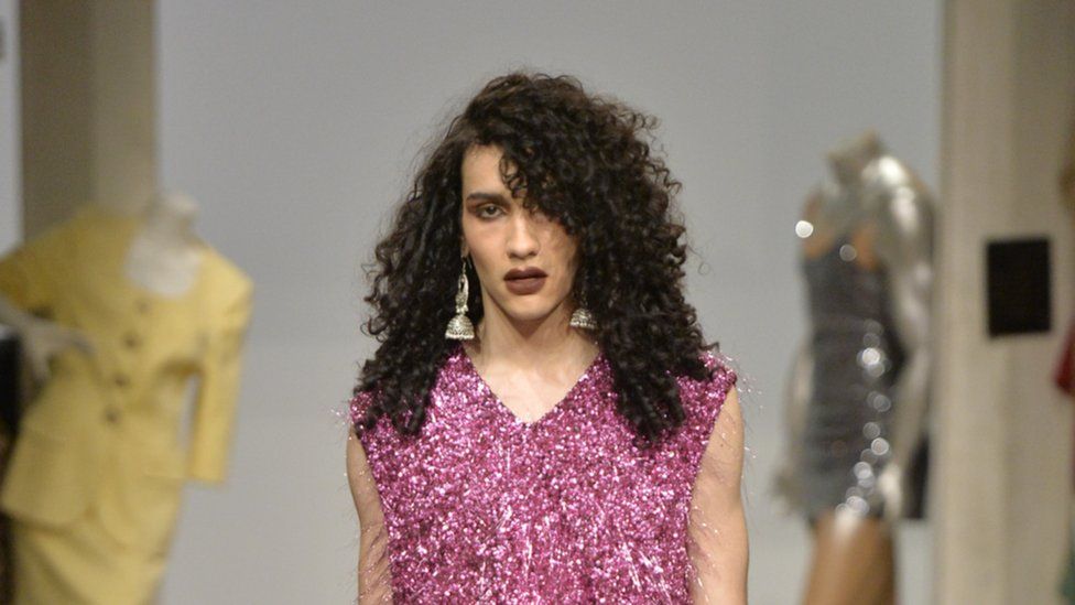 A male model with long curly hair