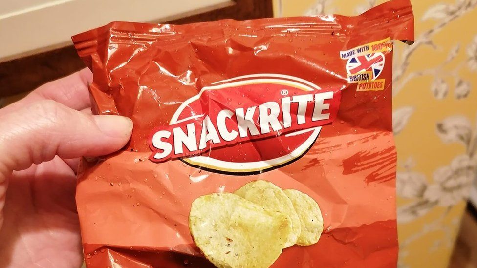 A crisp packet in a woman's hand