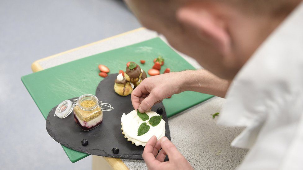 One of the finalists puts the finishing touches to his trio of desserts