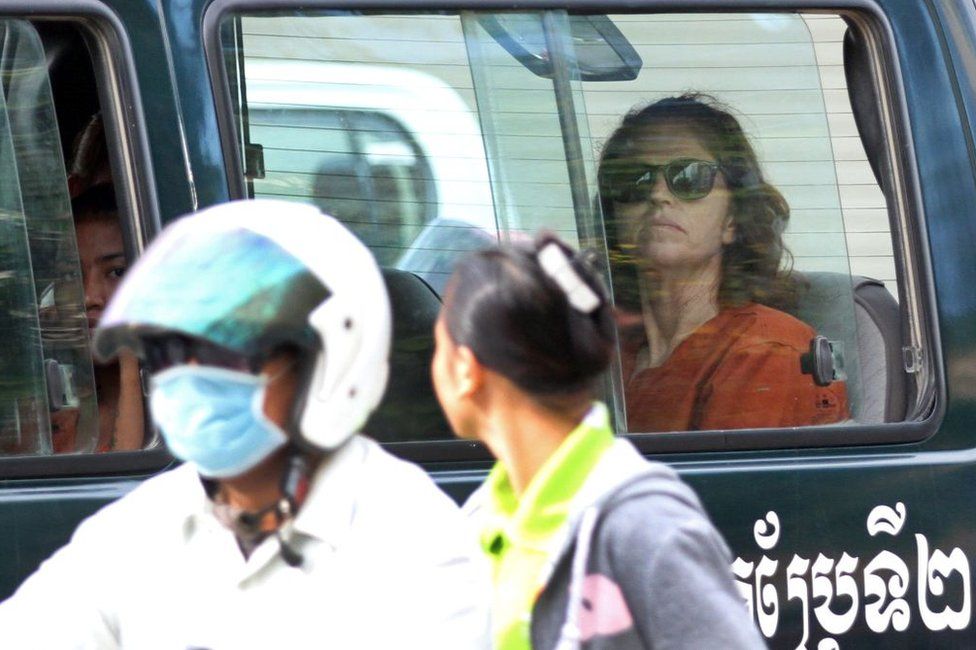 Australian national Tammy Davis-Charles (R), 49, sits in a prison car as she travels to Phnom Penh municipal court on 13 June 2017