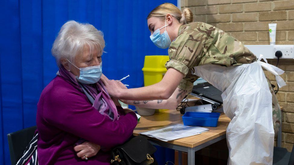 A woman getting vaccinated earlier in the pandemic, in Wales