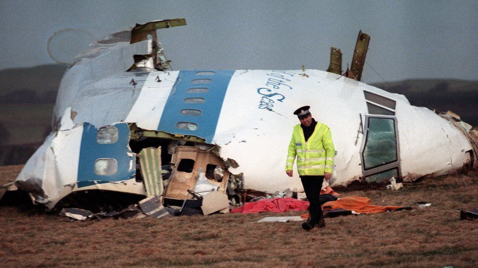 A Policeman walks away from the cockpit of the 747 Pan Am airliner that exploded and crashed over Lockerbie, Scotland, 22 December 1988