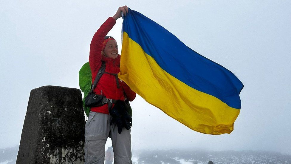 Sofiia Volovyk plants Ukrainian flag at the summit of Ben Nevis
