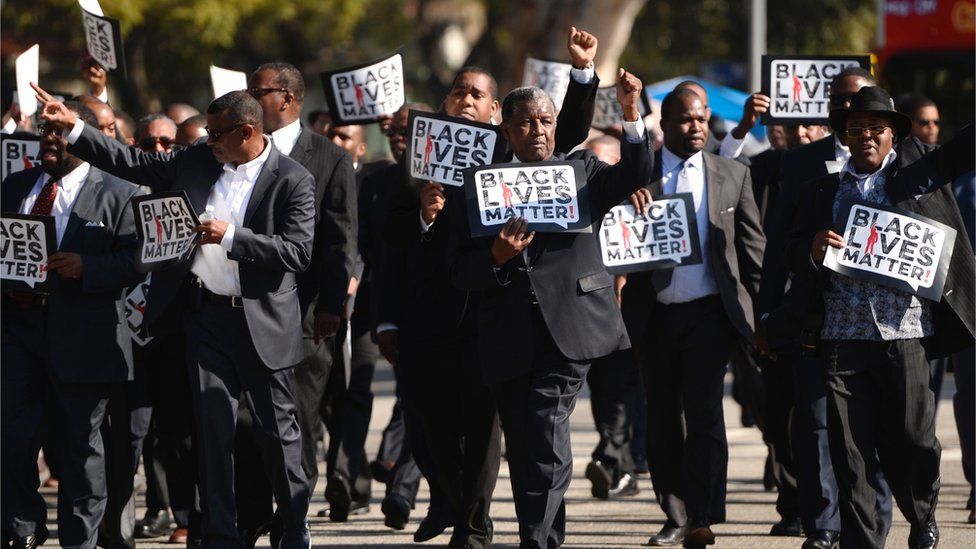 This file photo taken on 19 January 2015 shows men holding signs reading "Black Lives Matter" march in the 30th annual Kingdom Day Parade in honour of Dr Martin Luther King Jr