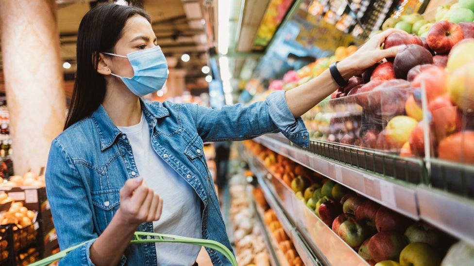 Stock image of a woman buying fruit