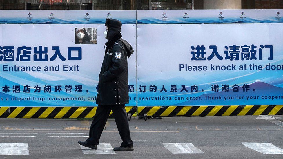 Security guard walking past closed loop premises at Olympics venue