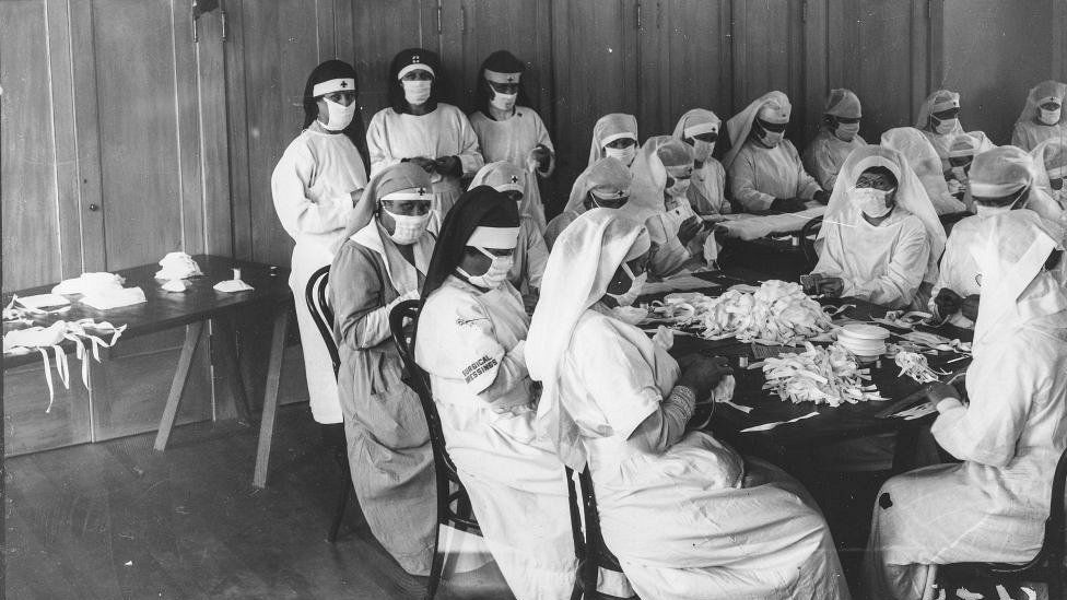 Red Cross nurses wearing masks