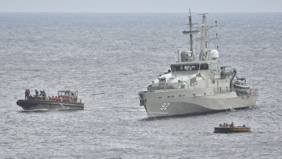 An Australian Navy vessel pictured beside an asylum seeker boat