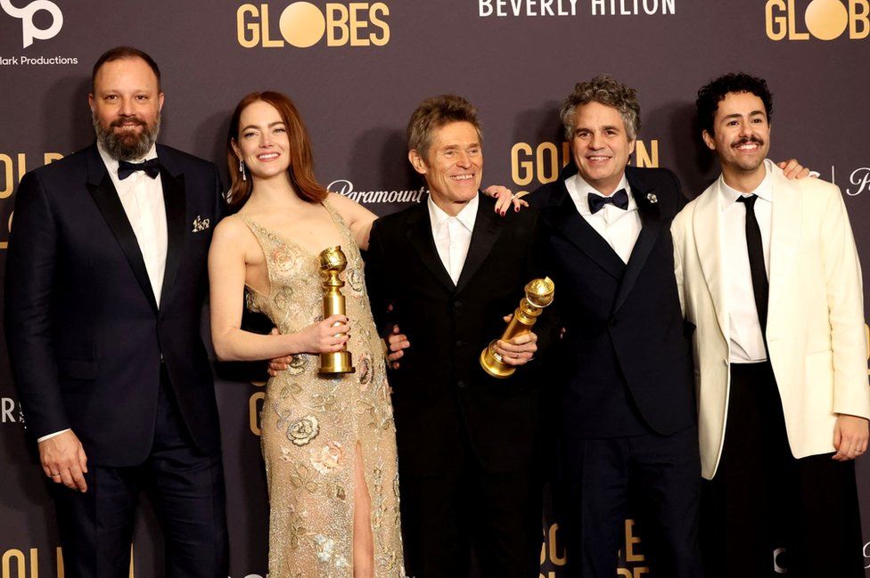 Filmmaker Yorgos Lanthimos (far left) with the Poor Things cast - Emma Stone, Willem Dafoe, Mark Ruffalo and Ramy Youssef at the 81st Annual Golden Globe Awards