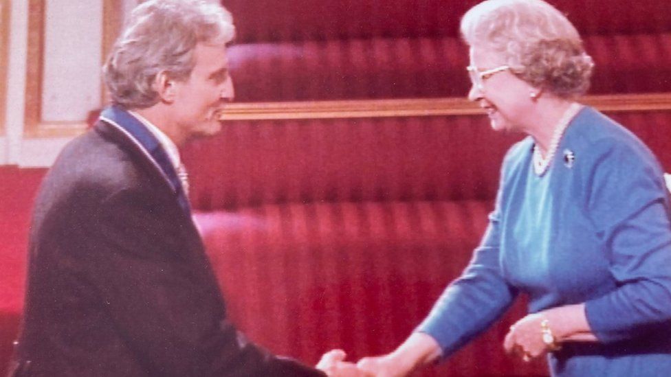 Charles Anson shaking hands with the Queen