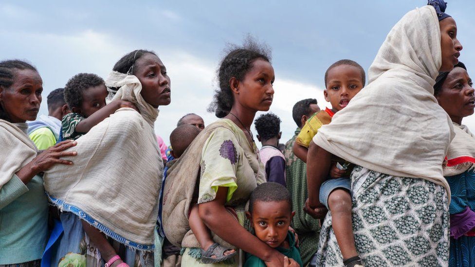Internally displaced people (IDP's) from various woredas throughout North Gonder wait to retrieve Food Aid being distributed by the Amhara Emergency Fund at the Millennium School on October 10, 2021 in Debark, Ethiopia