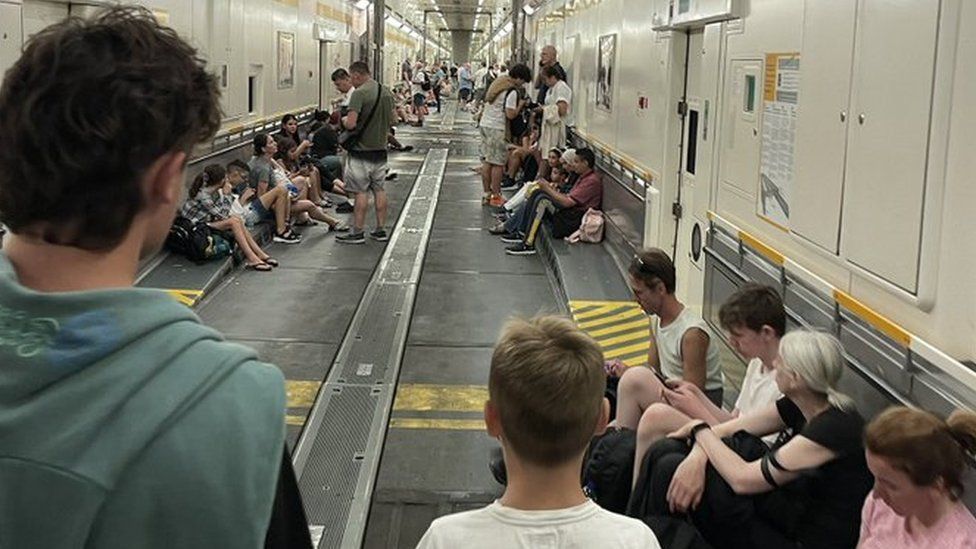 A photo showing the inside of a cargo train where passengers were transferred to