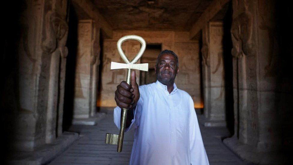 Egyptian temple guard Abd El-Sayed holds the Key of the temple to lock it after the end of the visit to the temple ruins from the 3200-year-old Abu Simbel temple, at the upper reaches of the River Nile in Aswan, Egypt - Monday 1 May 2023