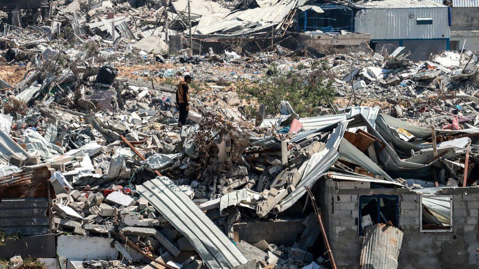 A man stands in the midst of devastation in Khan Younis after 4 months of Israeli bombardment in Khan Yunis