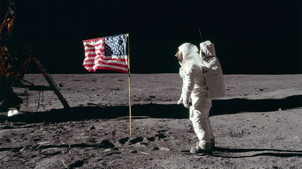 Buzz Aldrin salutes the US flag