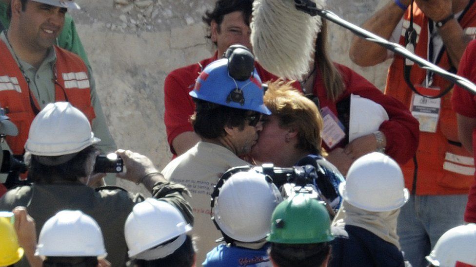 Chilean miner Yonni Barrios kisses his girlfriend after being rescued from the San Jose mine near Copiapo