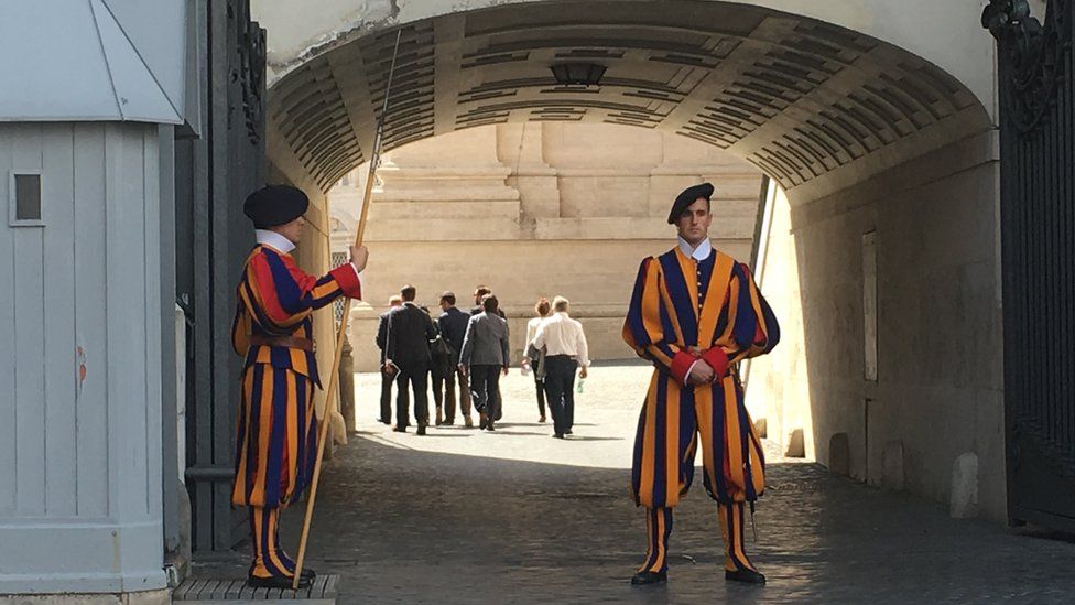 Swiss Guards protect the Vatican as journalists walk to trial
