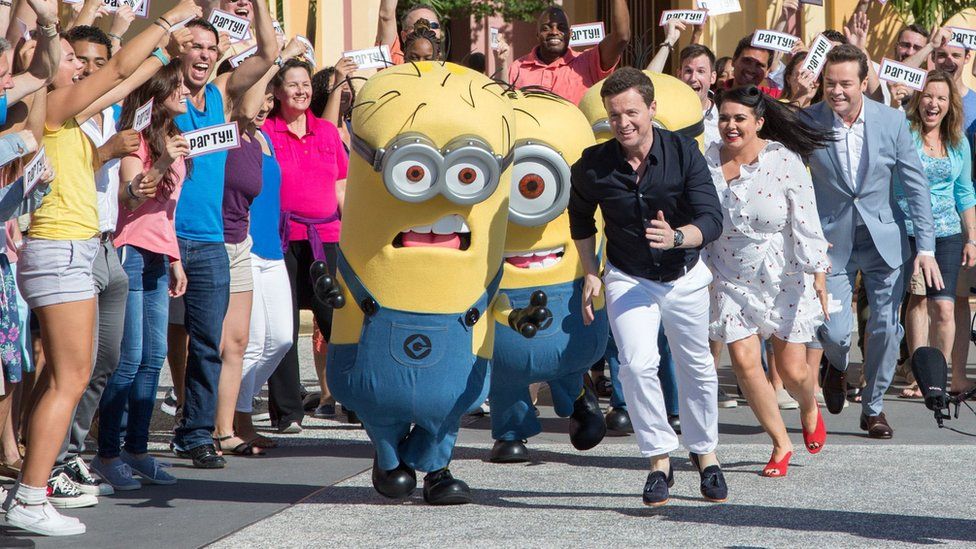 Declan Donnelly, Scarlett Moffatt and Stephen Mulhern with a group of minions during filming