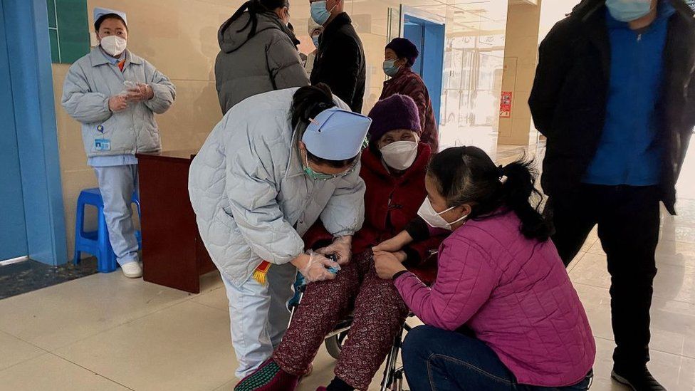 An elederly woman is helped at a hospital in China's Anhui province