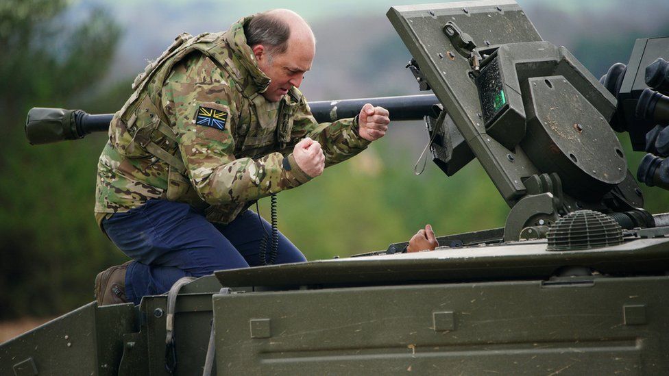 Defence Secretary Ben Wallace speaks to the crew inside an Ajax armoured personnel carrier after a demonstration during a visit to Bovington Camp military base in Dorset