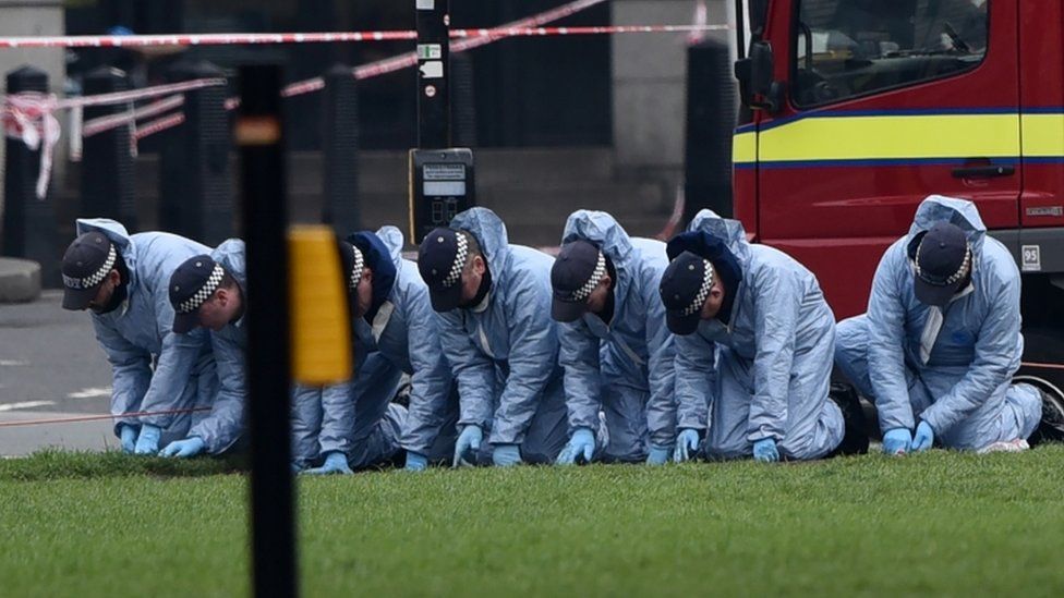 Police forensic officers work in Parliament Square