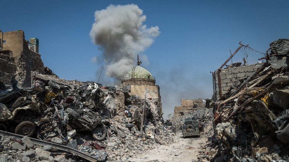 Top of a mosque in Iraq with an explosion
