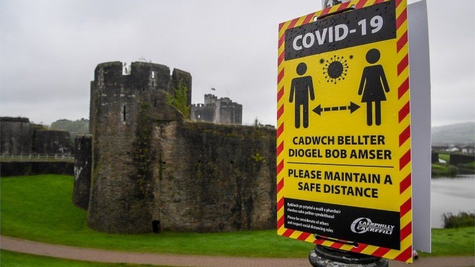 Social distancing sign outside Caerphilly Castle