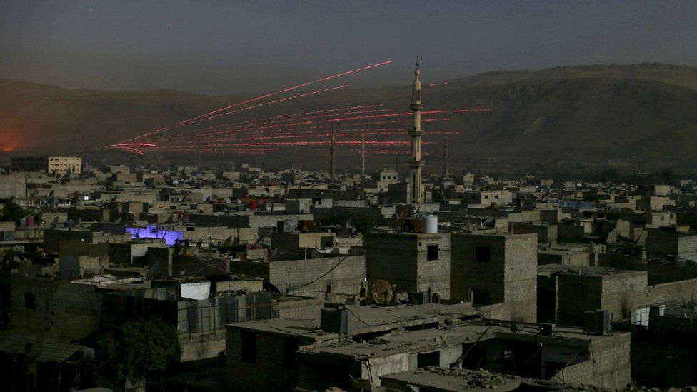 A fire trail is seen during clashes between forces loyal to Syria"s President Bashar al-Assad and the Army of Islam fighters near Damascus, Syria October 1, 2015