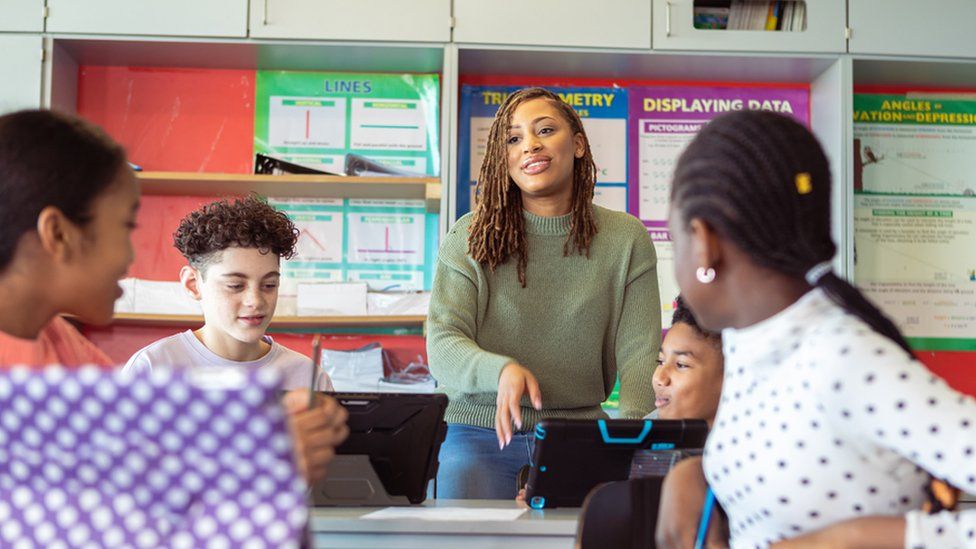 Stock image of a teacher and students in class
