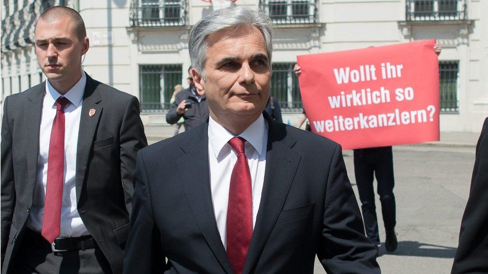 A protester holds up a placard calling for Werner Faymann's resignation (9 May)