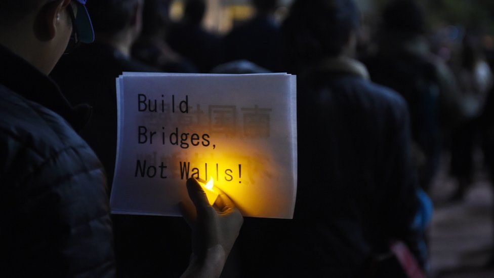 People attend a rally and candlelight vigil in Los Angeles, California