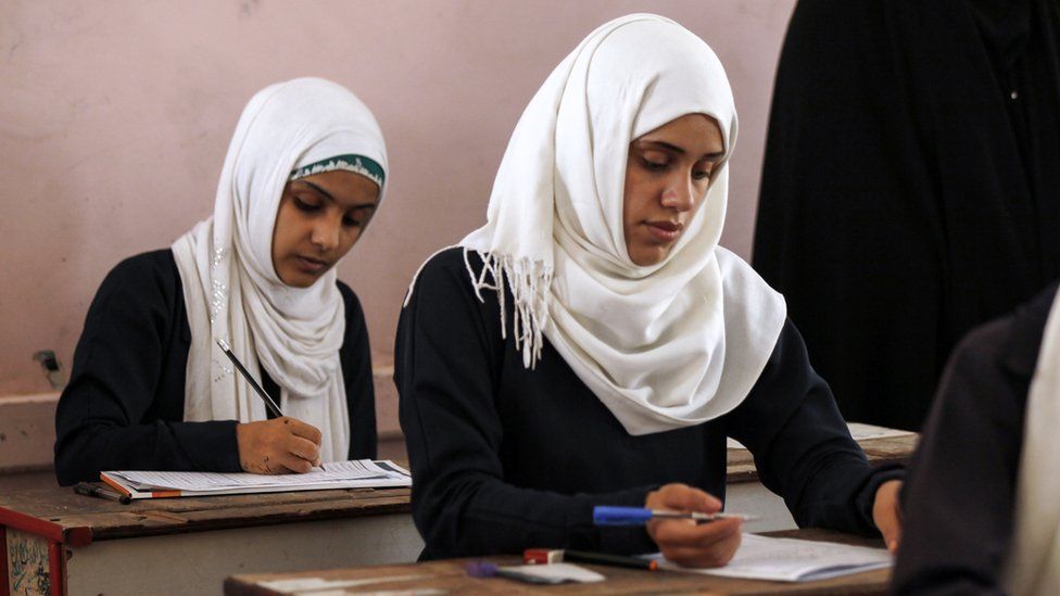 Female Yemeni students sit at a final exam in a secondary school in Sanaa
