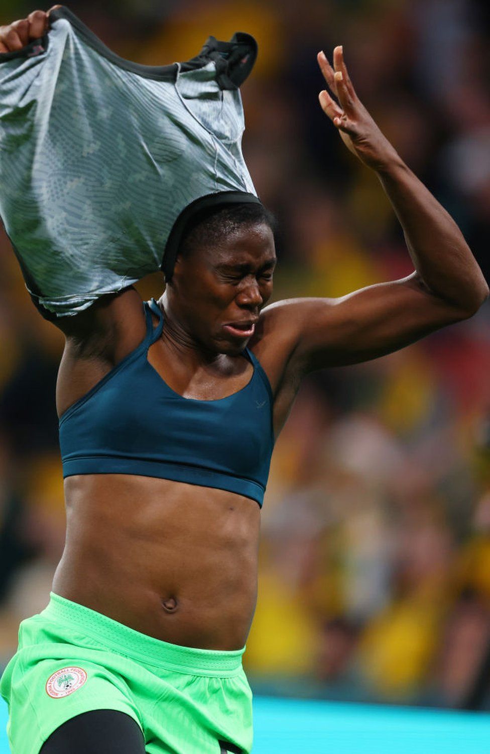 A female footballer takes her shirt off while celebrating a goal on Thursday.