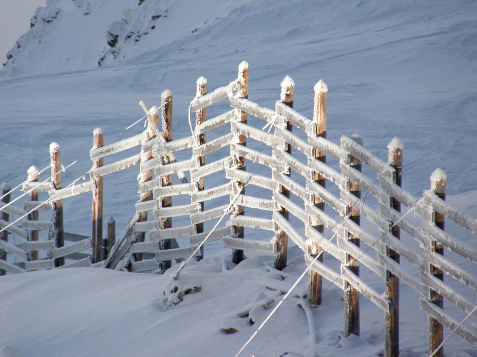 A fence marking the boundary of the piste in Les Arcs, ski resort in Bourg-Saint-Maurice, France.