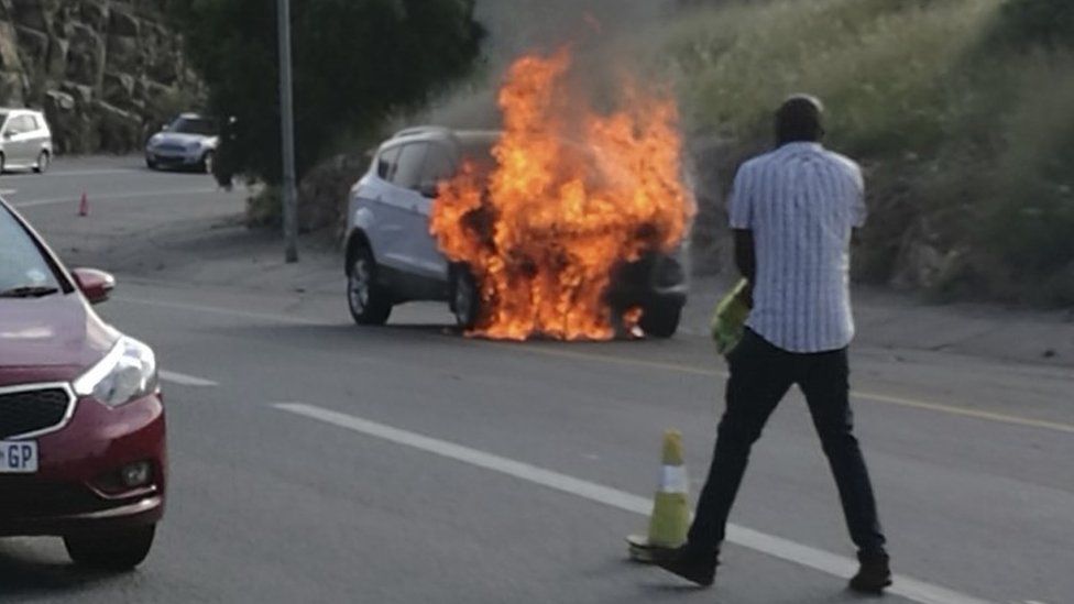 In this photo taken Thursday, Jan. 12, 2017 the 2013 Ford Kuga owned by Warren Krog burns out in Alberton Johannesburg