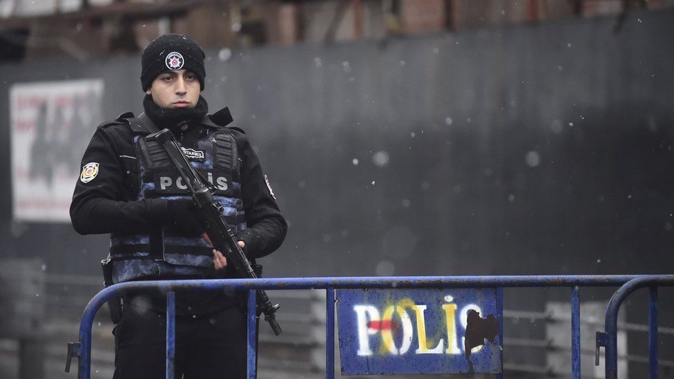 A Turkish police officer stands guard close to the site of an armed attack near the Reina night club on 1 January 2017