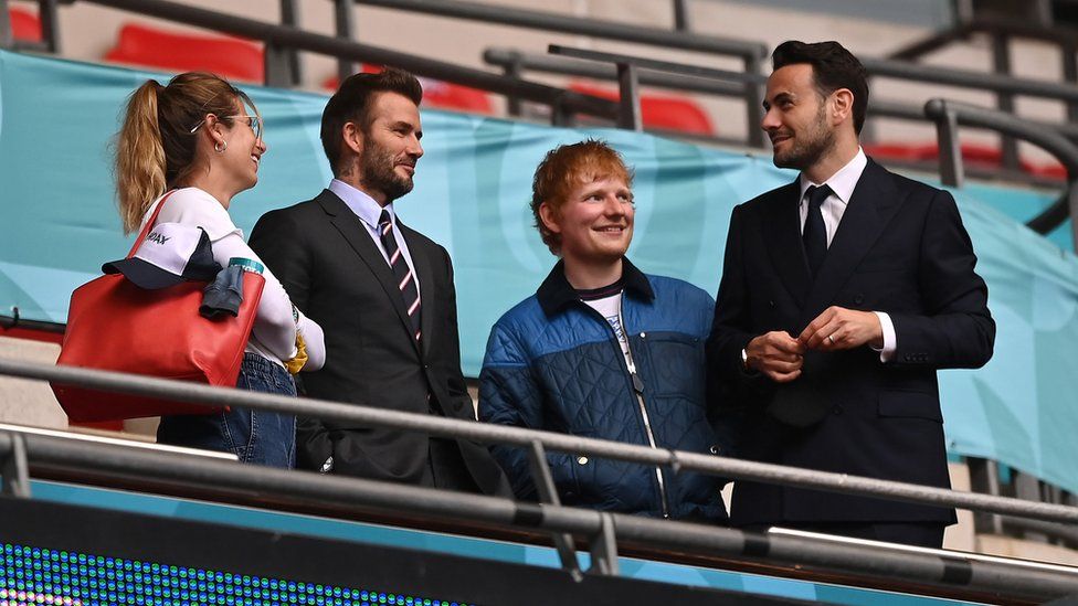 Cherry Seaborn, wife of Ed Sheeran, David Beckham and Ed Sheeran are seen in the stands at Wembley stadium