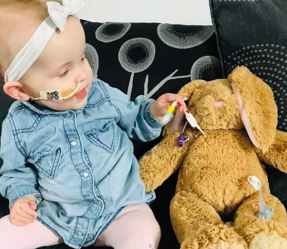 One-year-old Darcey with her tube bunny