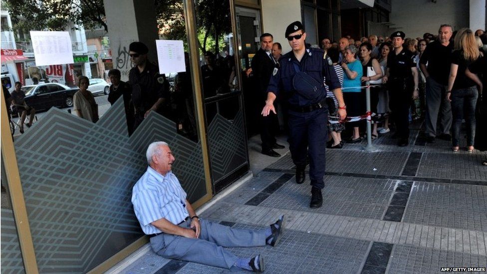 An elderly man is crying outside a national bank branch as pensioners queue to get their pensions, with a limit of 120 euros, in Thessaloniki on 3 July, 2015.