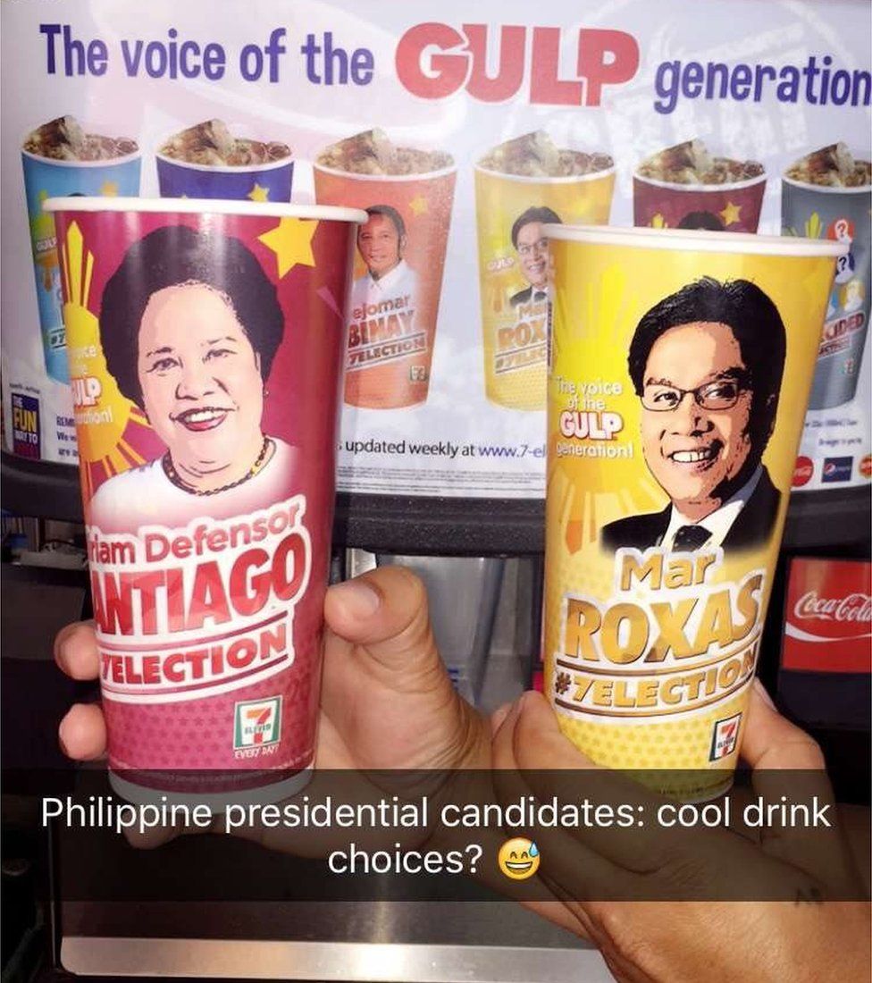 Two cups - red for Miriam Defensor Santiago, yellow for Mar Roxas - held up to the camera, with text across the image reading "Philippine presidential candidates: cool drink choices?"
