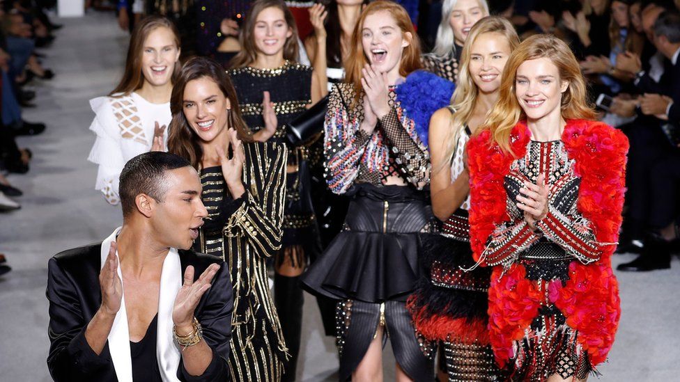 Olivier Rousteing (left) acknowledges the audience at the end of Balmain women's 2018 Spring/Summer ready-to-wear show