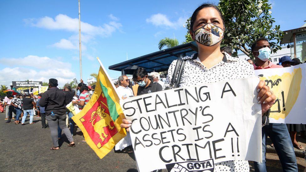 Sri Lankan anti-government protester holds a placard during a protest demanding the Sri Lankan president Gotabaya Rajapaksa to resign at Colombo.