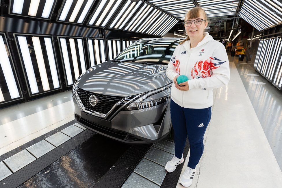 Anna Nicholson with her shot put and a Nissan car